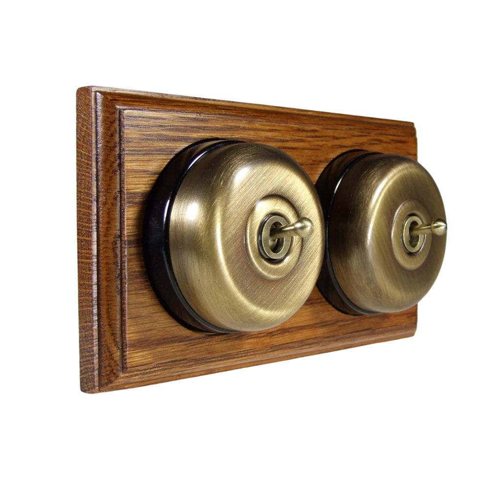 Period Smooth Antique Brass Dome Double Dolly Light Switch Medium Oak Black Horizontal