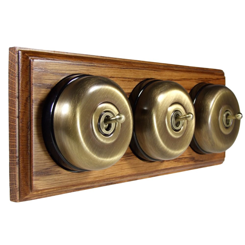 Period Smooth Antique Brass Dome Triple Dolly Light Switch Medium Oak Black Horizontal