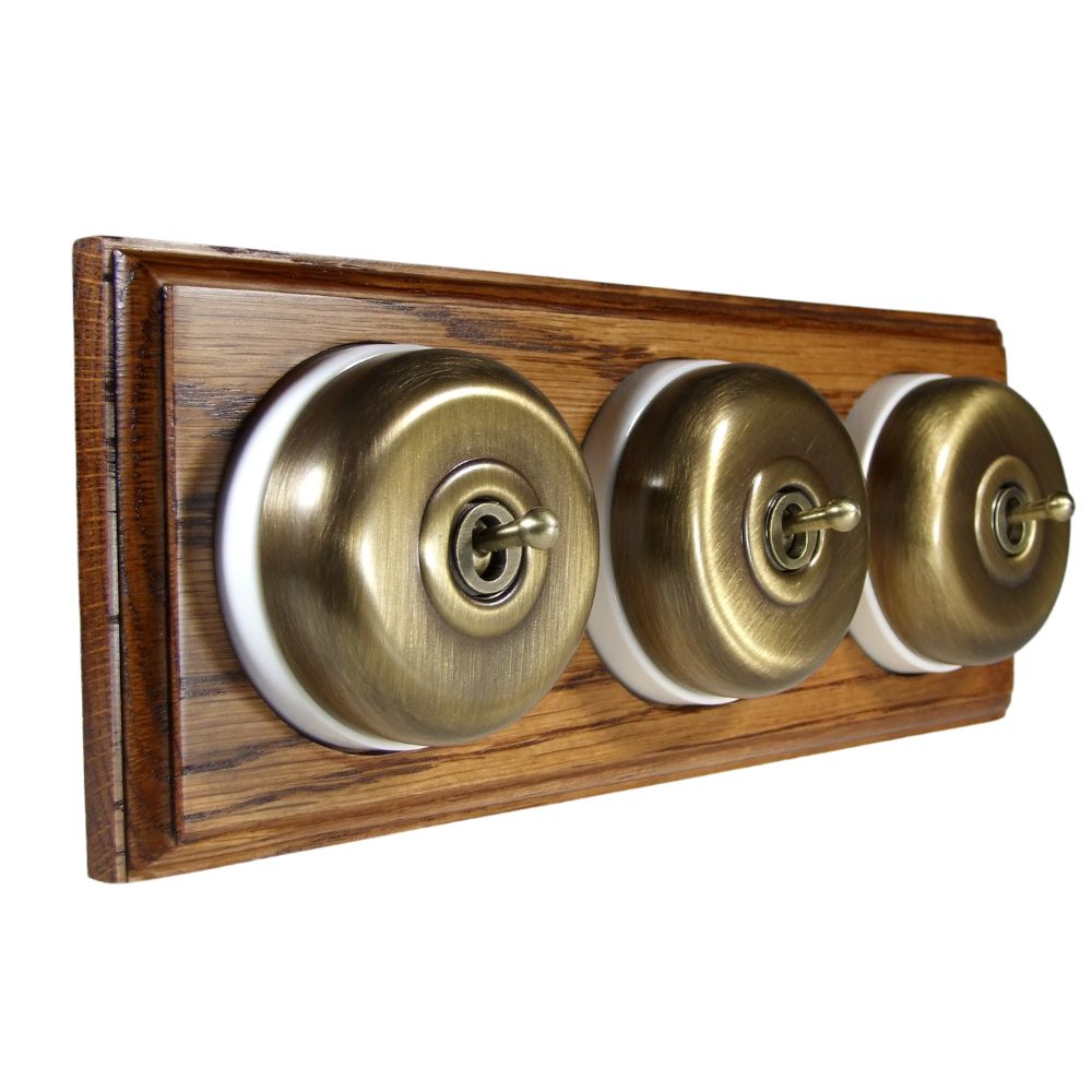 Period Smooth Antique Brass Dome Triple Dolly Light Switch Medium Oak White Horizontal