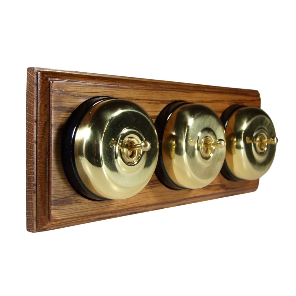 Period Smooth Polished Brass Dome Triple Dolly Light Switch Medium Oak Black Horizontal