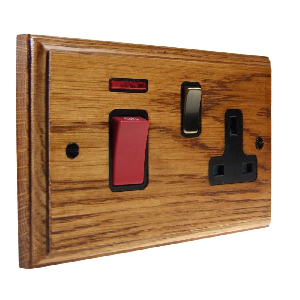 Classic Medium Oak Double Pole Cooker Switch with Single Switched Socket Antique Brass and Black